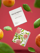 dolce fresca bath bomb by bare skin bar in grey box shown with grapefruit and basil leaf
